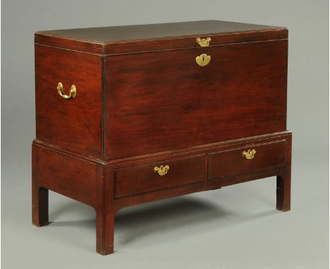 A George III mahogany chest on stand, with caddy top with brass drop handles, the base fitted with two drawers and raised on 