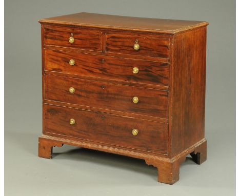 A George III mahogany chest of drawers, with two short and three long graduated drawers with brass drop handles with circular