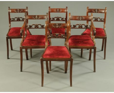 A set of six Regency mahogany dining chairs, two arm and four single chairs, each with bowed top rail, shaped stiles, drop in