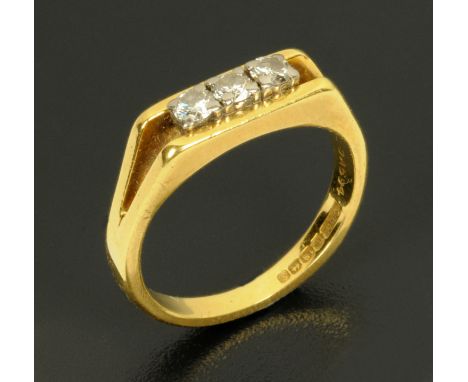 An 18 ct gold three stone diamond ring, size K. 