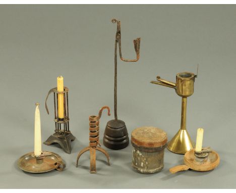 A collection of six lamps and candle holders, including Victorian oil lamp, four candlesticks, modern rush light holder, and 
