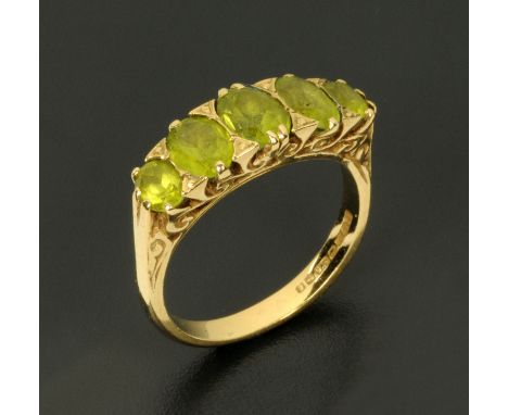 A 9 ct gold ring, set with five peridot, size R.