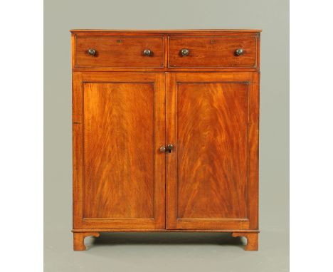 A 19th century mahogany linen cupboard, with two drawers above a pair of panelled cupboards doors enclosing shelves and raise