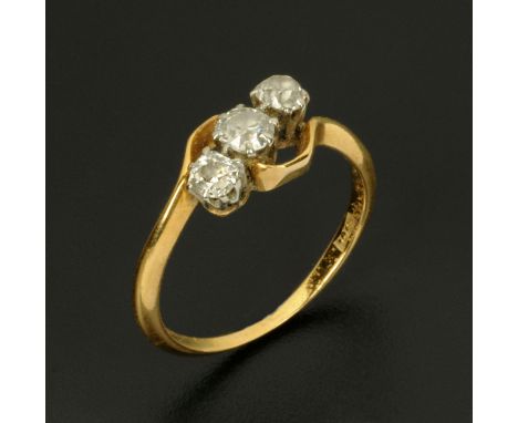 An 18 ct gold three stone diamond ring, size Q/R.