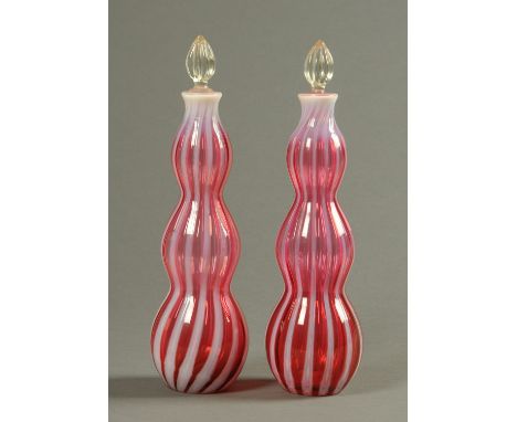 A pair of Edwardian triple gourd ruby and milk glass decanters, each with stopper.  Height 36 cm.  