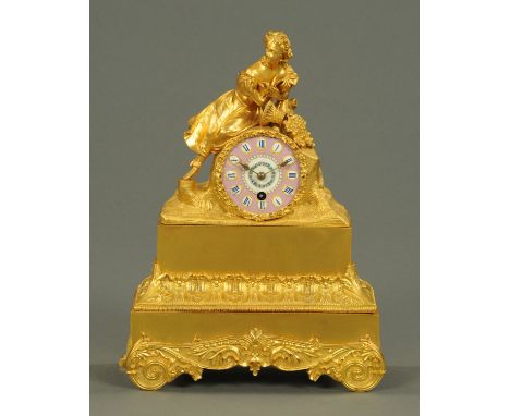 A late 19th century French figural mantle clock, with pink porcelain dial.  Height 37 cm. 