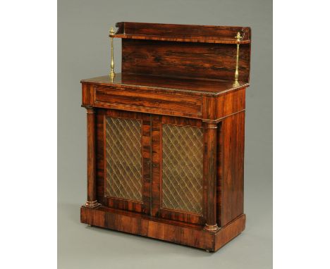 A Regency rosewood chiffonier, with rear shelf, brass columns, frieze drawer, pair of doors with brass grilles and raised on 