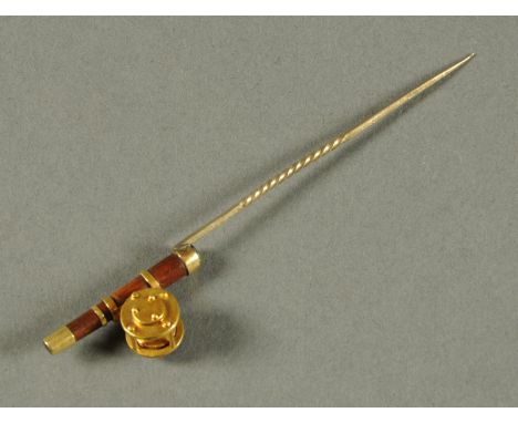 A gold plated fishing rod and reel stick pin.  Length 9.5 cm. 