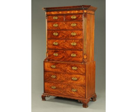 A George III mahogany Channel Islands tallboy, with inverted breakfront cornice with canted angles above a crossbanded and in
