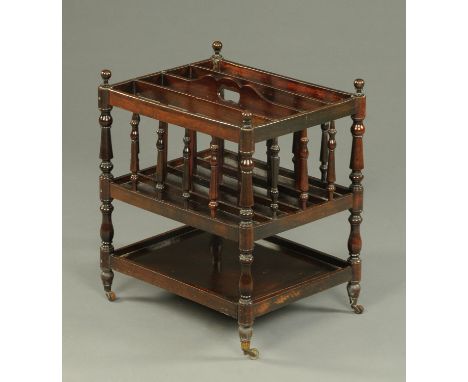 A late Victorian mahogany Canterbury, four divisions, with turned supports, low shelf and castors.  Width 42 cm.    CONDITION