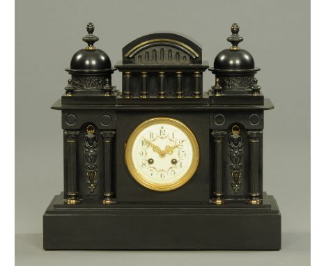 A late Victorian black slate mantle clock, with ceramic dial with Arabic numerals and two-train striking movement.  Height 40