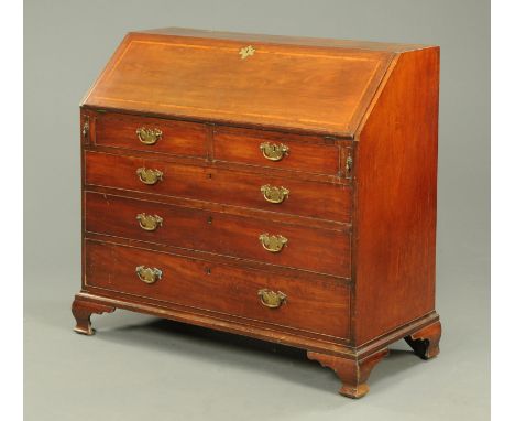 A George III mahogany bureau, with crossbanded slope front, two short and three long graduated drawers with brass drop handle