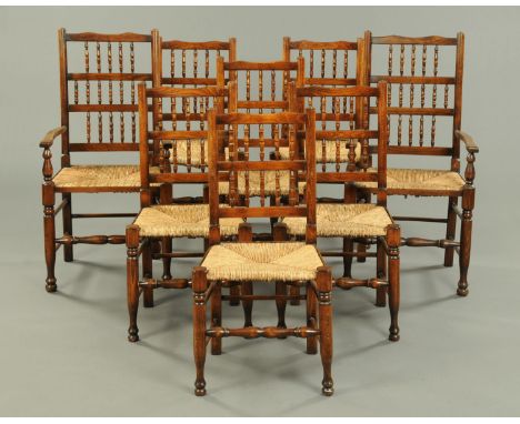 A set of two carver arm and six single Lancashire style spindle back rush seated dining chairs (see illustration).   CONDITIO