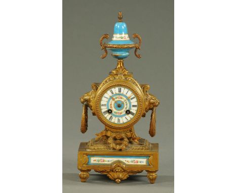 A Victorian spelter and porcelain mantle clock, with urn and cover finial, two-train movement.  Height 36 cm, width 17 cm. 