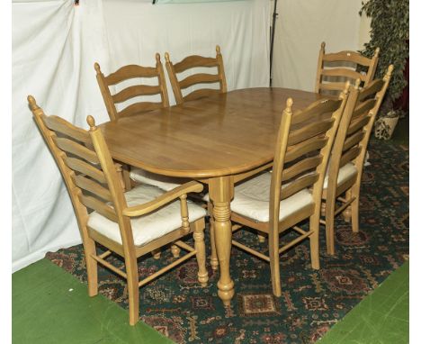 A modern light oak table, four dining chairs and two carvers