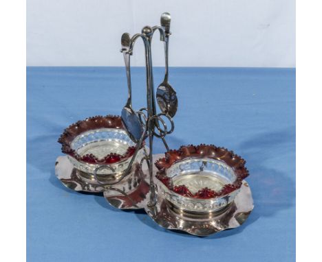 A silver plated stand with ruby glass edged preserve dishes