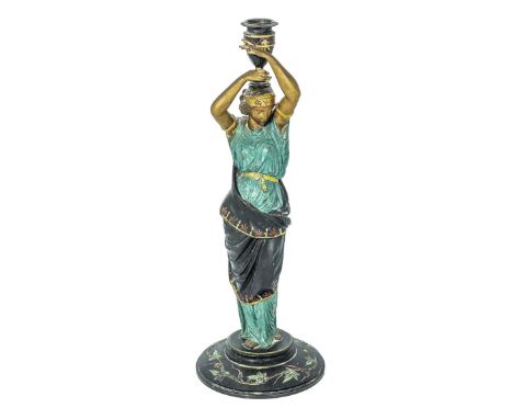 A painted spelter classical figure candle stick 39cm tall