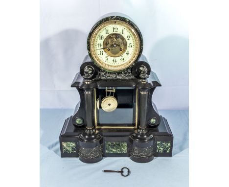A Victorian drumhead slate and marble mantel clock, white enamel face with visible escapement, glass panel showing pendulum, 