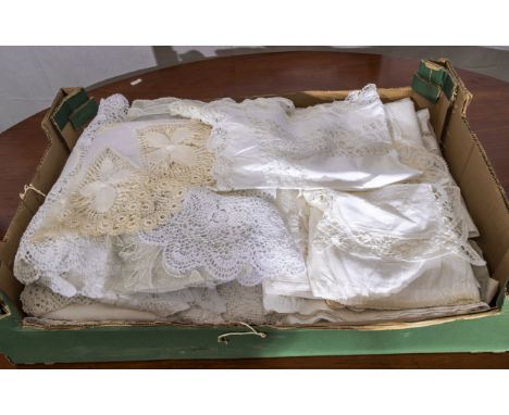 A box containing vintage lace and linen