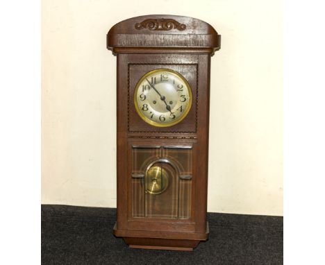 An Edwardian oak wall clock