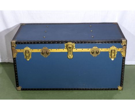 A large blue vintage steamer trunk