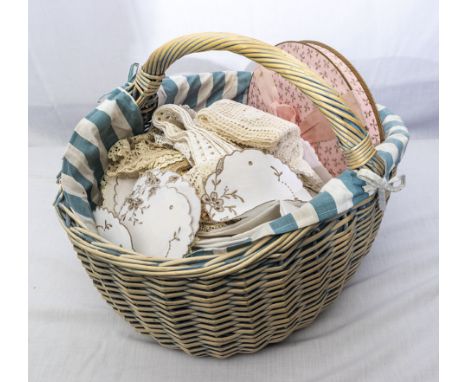 A basket of vintage table linen and lace