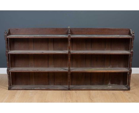 An antique oak four-tier wall shelf or dresser rack, 190cm wide, 20cm deep, 95cm highSurface scratches, marks and wear.