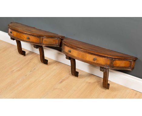 A pair of reproduction walnut console tables each 67cm wide x 25cm deep x 33cm highSome veneer loss to the tops at the back, 