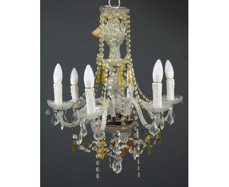 A cut glass six branch chandelier with two layers of trailing cut glass clear and amber coloured drops on a central bobbin tu