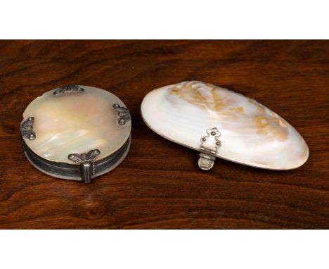 An early 20th century continental white metal and mother of pearl magnifying glass, 6cm diameter, together with an early 20th