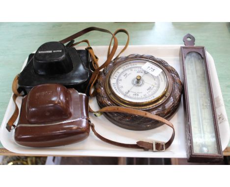 A 19th Century mahogany thermometer by S Jones London, a circular carved oak barometer plus two cameras