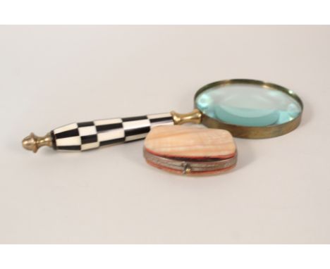 A magnifying glass with chequered handle plus a mother of pearl purse