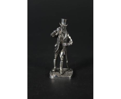 A silver model of a man with gun (as found)