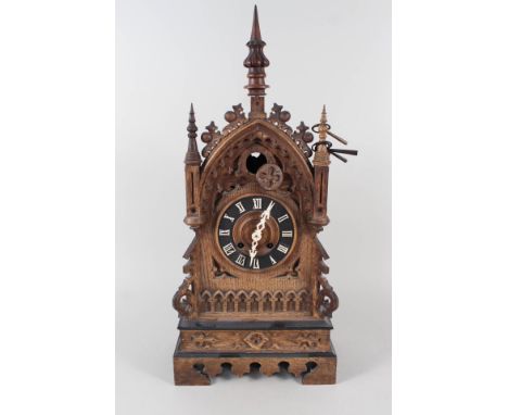 An oak cased steeple cuckoo clock