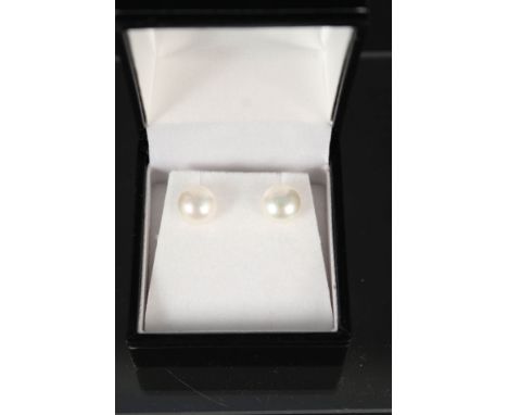 A pair of 9ct gold single pearl stud earrings