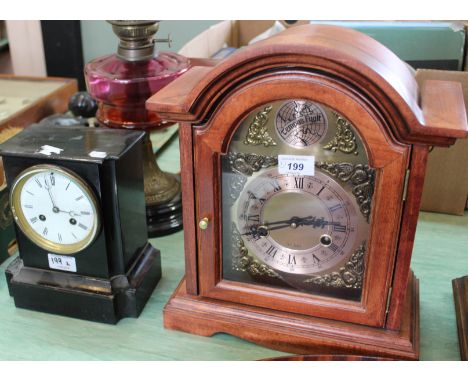A modern mahogany striking mantel clock plus an ebonised clock