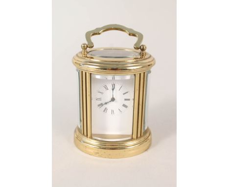 A small oval brass carriage clock