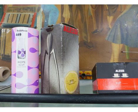 A PHILIPPE STARCK ALESSI LEMON SQUEEZER, A PAIR OF ALESSI COFFEE CUPS AND SAUCERS AND BODANOVA HOPE KARAFF.