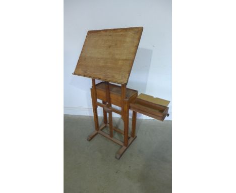 A G Robinson and Co of 99 Longcase London - light oak Artists Easel table with a side  drawer and adjustable easel - Width 66