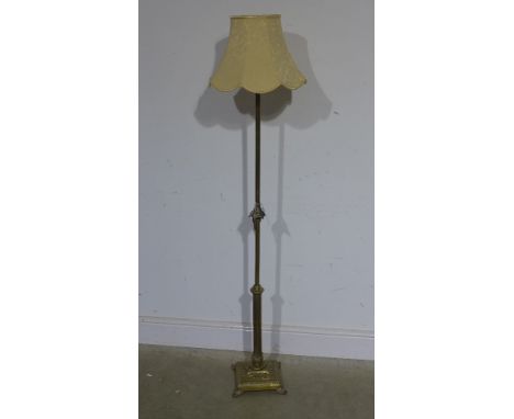 An early 20th century ornate brass standard lamp with primrose shade - needs re wiring, telescopic action not operating
