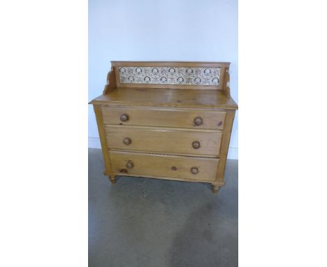 A Victorian stripped pine washstand chest with attractive tile back over three long drawers - Height 106 m x Width 1.07 m x D