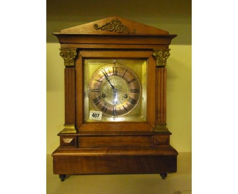 A walnut striking mantel clock 