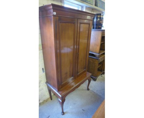 A mahogany cupboard on a cabriole leg stand with a shelved interior - Height 1.69 m - Base 48 cm deep - Shelf depth 30 cm 