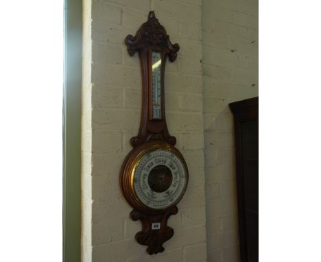 A carved oak Aneroid Barometer with Thermometer - Height 90 cm