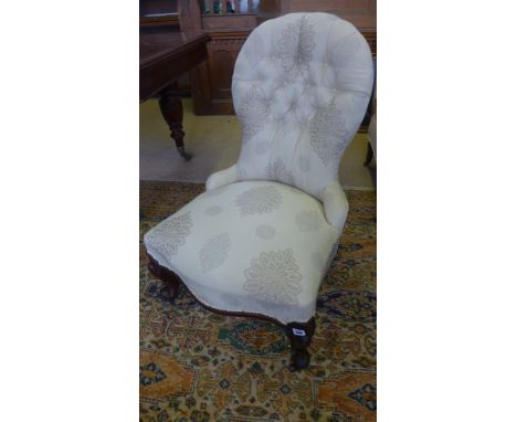 A re-upholstered Victorian button back chair