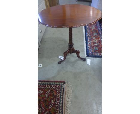 A 19th century mahogany tripod side table with a shaped top - Height 66 cm x 61 cm x 44 cm 