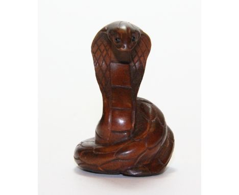 A carved wooden snake netsuke H 5cm