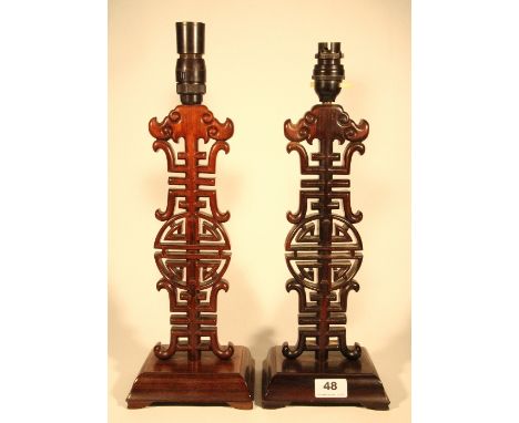 A pair of Chinese carved hardwood character lamp bases H 37cm