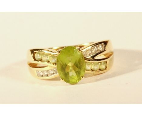 A 9ct gold peridot and diamond ring (K.5)