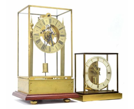 Modern brass electric mantel clock, the 6.25" brass dial enclosing a skeletonised movement, supported upon fluted turned spik